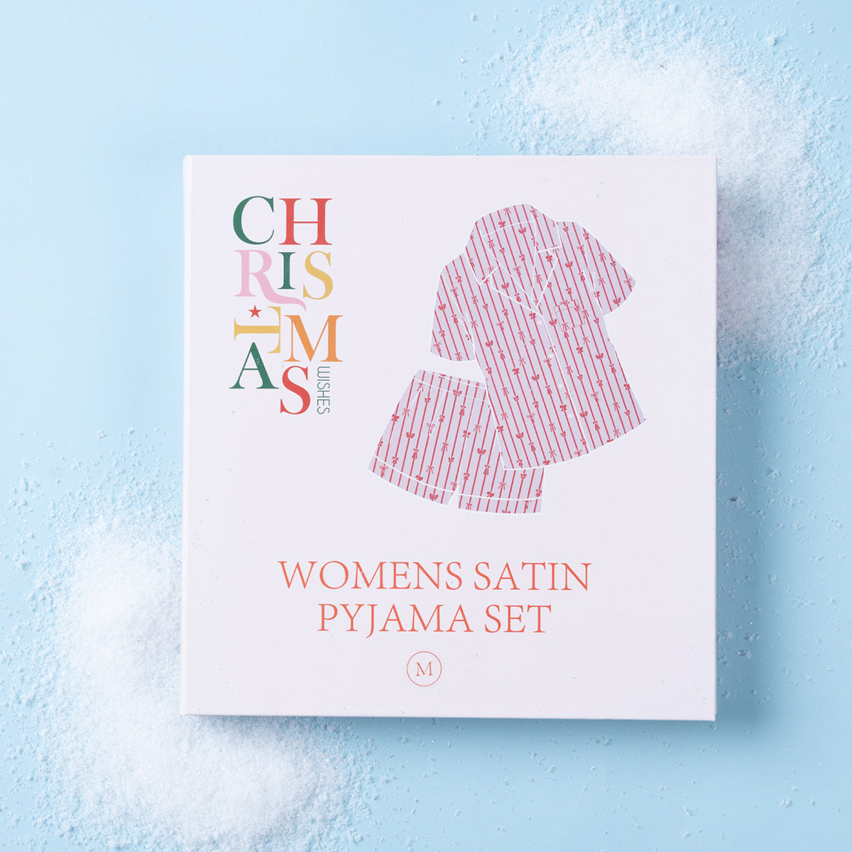 Christmas Wishes Women’s Satin Bow Pyjama Gift Set packaging displayed on a light blue background.