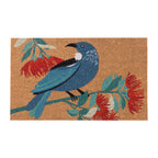 Christmas Wishes Xmas Tui Coir Mat featuring a blue tūī perched on a branch surrounded by red pōhutukawa flowers and green foliage against a natural coir background.