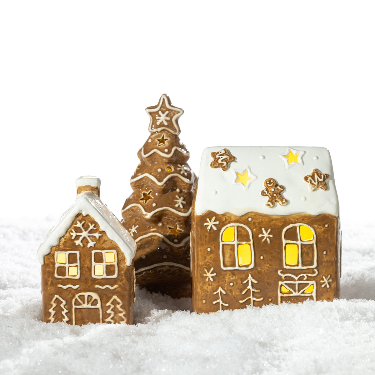 Gingerbread-style ceramic LED Christmas tree displayed with coordinating illuminated gingerbread houses in a snowy setting.