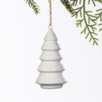 White ceramic Christmas tree hanging decoration with a tiered design and subtle ribbed detailing, suspended from a natural twine loop.