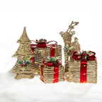 Christmas Wishes rattan Christmas tree, standing deer and illuminated gift box decorations with red ribbon, festive greenery and berry detailing.