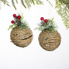 Christmas Wishes set of two rattan ball hanging decorations with glitter detailing, festive greenery, pinecones and red berries.