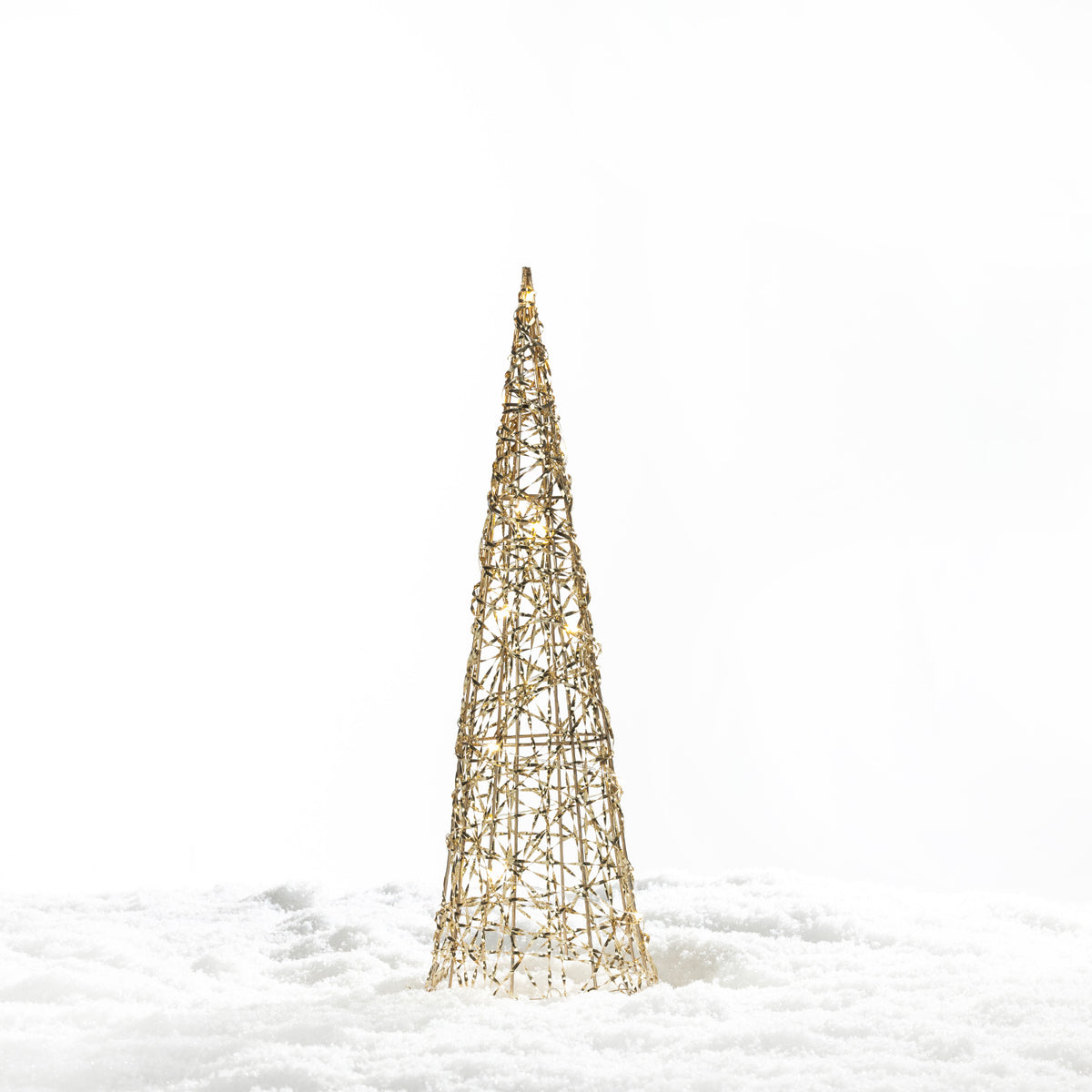 Christmas Wishes gold cone tree LED décor with an open woven design and warm white lights, displayed in a snowy setting.