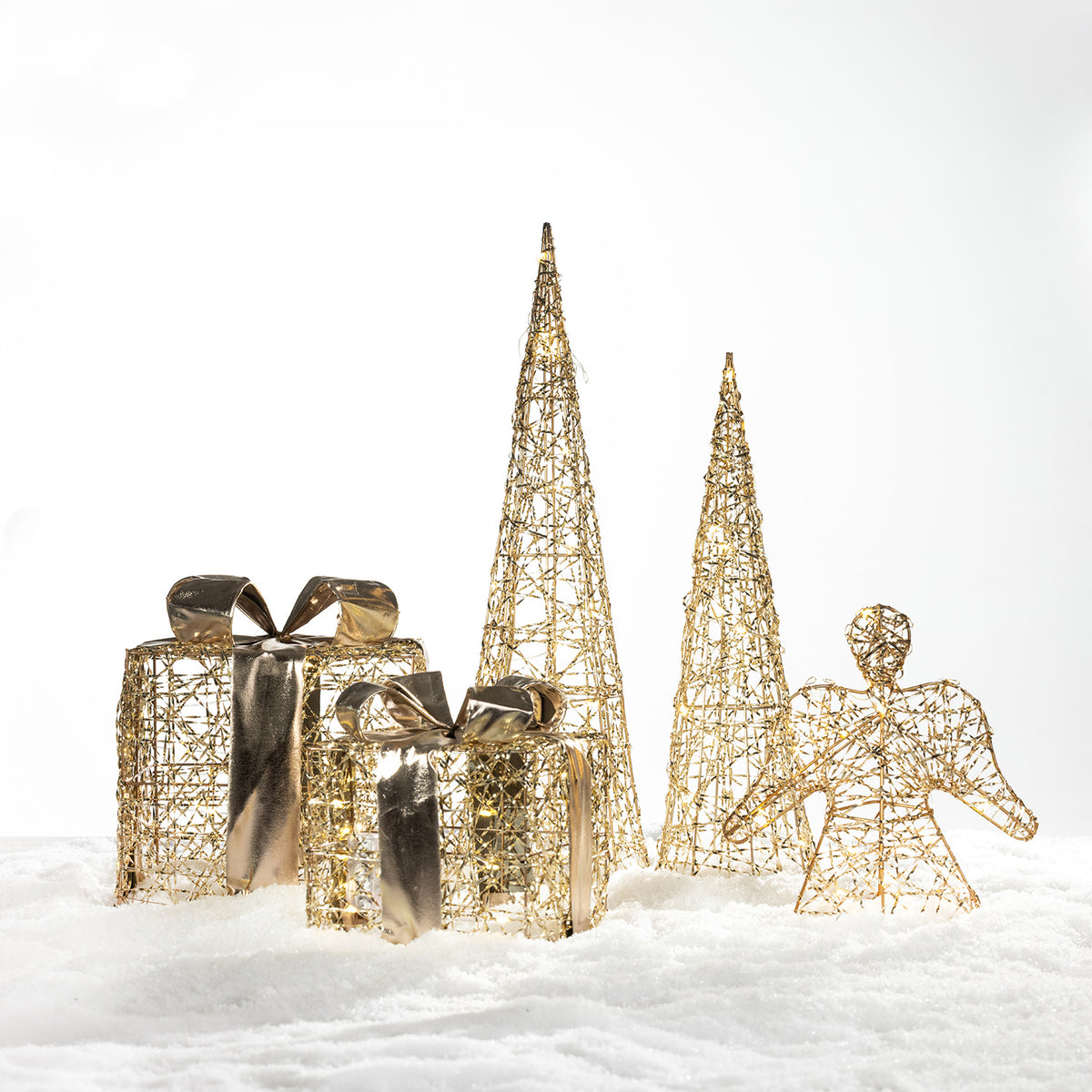Christmas Wishes gold present box LED decorations styled with coordinating gold Christmas trees and angel décor on a snowy background.