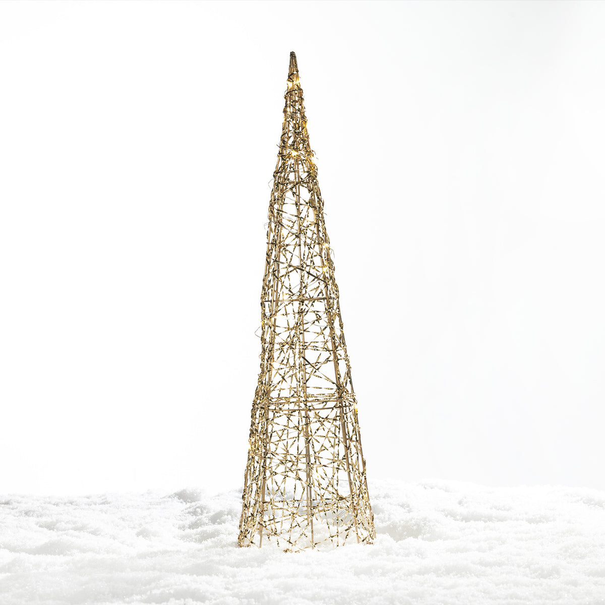 Christmas Wishes gold cone tree LED décor with an open woven design and warm white lights, displayed in a snowy setting.