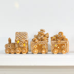 1. Gingerbread-style ceramic LED Christmas train featuring a Santa driver, snowman and gingerbread character with warm glowing lights.