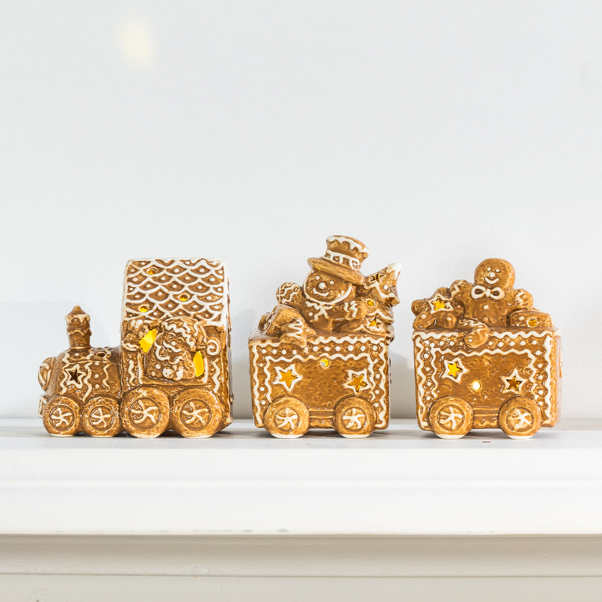 1. Gingerbread-style ceramic LED Christmas train featuring a Santa driver, snowman and gingerbread character with warm glowing lights.