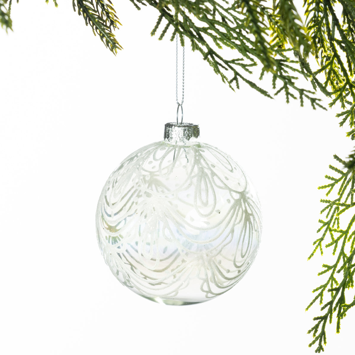 Christmas Wishes Clear White Lace Glass Bauble – Clear glass round bauble decorated with delicate white lace-inspired swirls and glitter detailing for an elegant, frosted Christmas look.