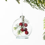 Christmas Wishes Mistletoe Snow Globe Bauble – Clear glass snow globe-style bauble featuring festive red berries, green foliage and delicate snowflake accents inside for a charming seasonal finish.