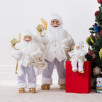 Three Christmas Wishes White & Gold Santa figures in different sizes displayed together beside a Christmas tree, featuring matching white and gold outfits and festive decorations.