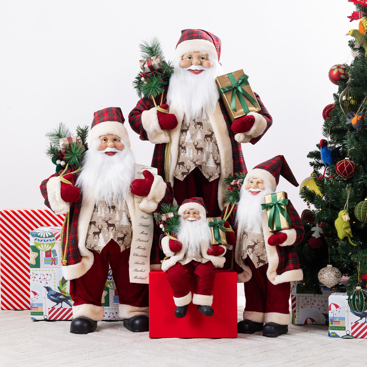 Christmas Wishes traditional Santa figures in coordinating red tartan and cream outfits, displayed together with festive gifts and greenery beside a Christmas tree.