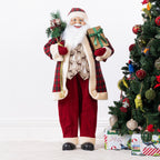 Christmas Wishes Red Traditional Santa 110cm dressed in a red tartan and cream-trimmed outfit, holding festive greenery and a gold gift with a green bow.