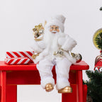 Christmas Wishes White & Gold Santa 80cm wearing a white and gold festive outfit, holding silver baubles and a sack of gold decorations beside a Christmas tree.