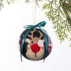 Christmas Wishes reindeer sock bauble featuring festive socks rolled inside a clear ornament with a reindeer face design, teal ribbon bow and hanging loop.