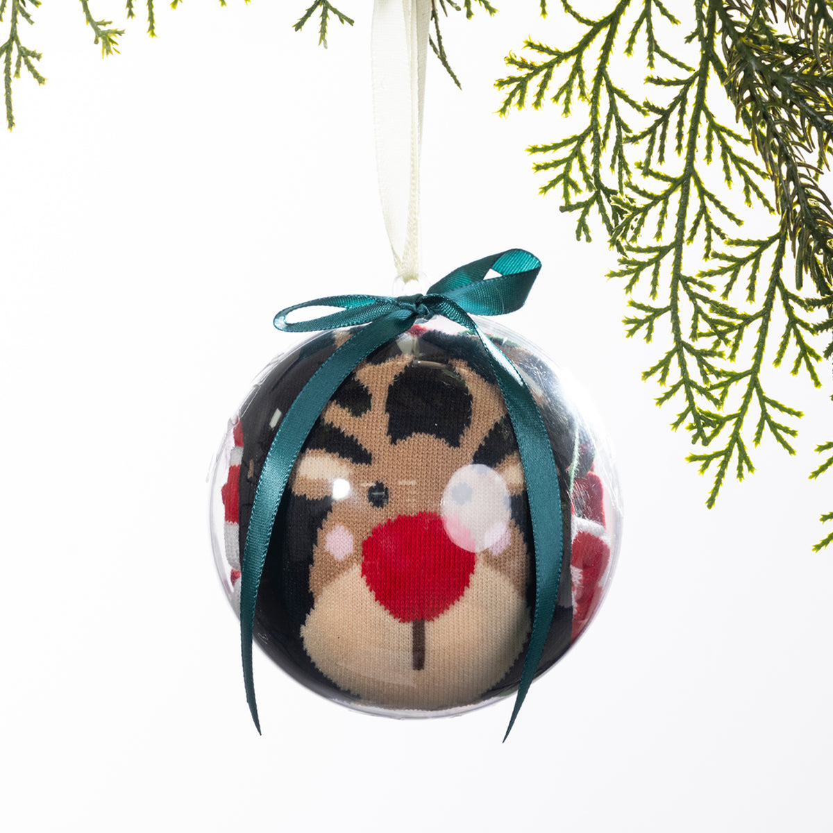 Christmas Wishes reindeer sock bauble featuring festive socks rolled inside a clear ornament with a reindeer face design, teal ribbon bow and hanging loop.