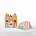 Gingerbread candy house cookie jar shown open and filled with gingerbread cookies, with its pink roof-shaped lid displayed alongside.