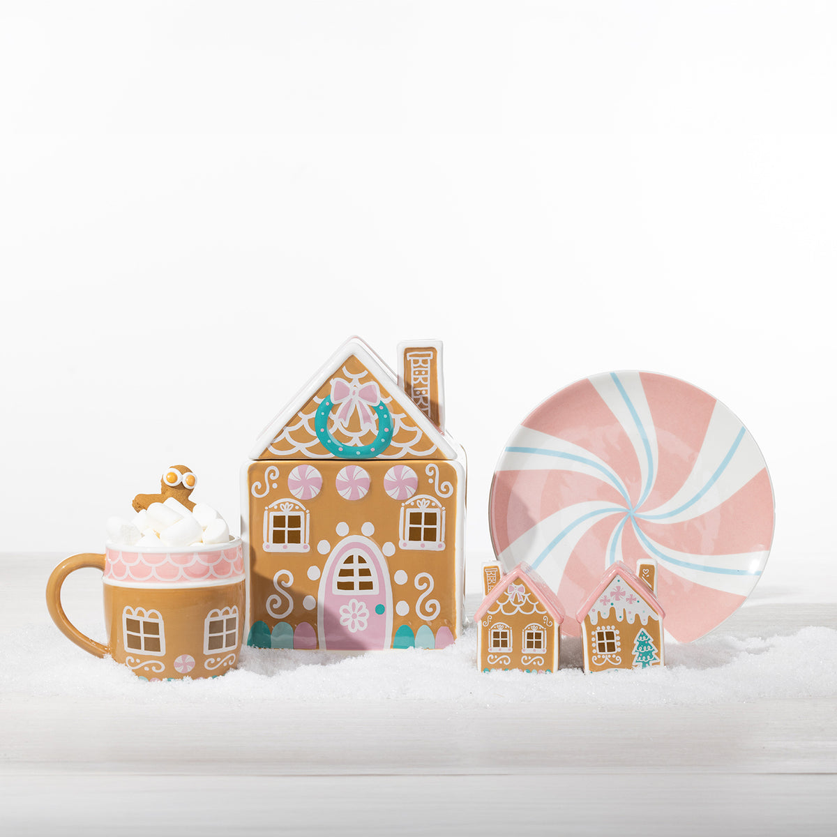 1. Christmas Wishes gingerbread collection featuring a gingerbread house mug, candy house cookie jar, peppermint plate and two decorative houses.