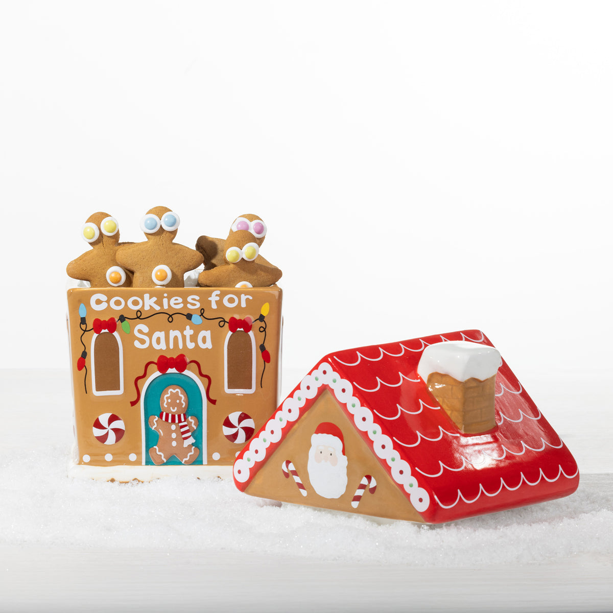 Christmas Wishes collection featuring two gingerbread house cookie jars, a Milk for Santa bottle and Christmas tree shaped cookie plate.