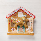 Gingerbread house shaped Christmas plate topped with gingerbread cookies, featuring Santa, candy canes, colourful lights and “Cookies for Santa” lettering.