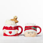 1. Two-piece Mrs Claus mug set displayed separately, with one mug topped with whipped cream and a gingerbread man and the other filled with marshmallows.
