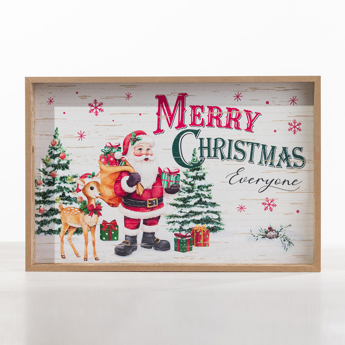 A rectangular wooden shadow box tray featuring a festive Christmas design with Santa Claus, a deer, Christmas trees, gift boxes, and the words 'Merry Christmas Everyone' on a whitewashed wood background.