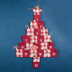 Christmas Wishes Christmas Tree Pocket Advent Calendar Red – Red and plaid fabric Christmas tree-shaped advent calendar with numbered pockets from 1 to 24, styled with festive treats against a blue background.