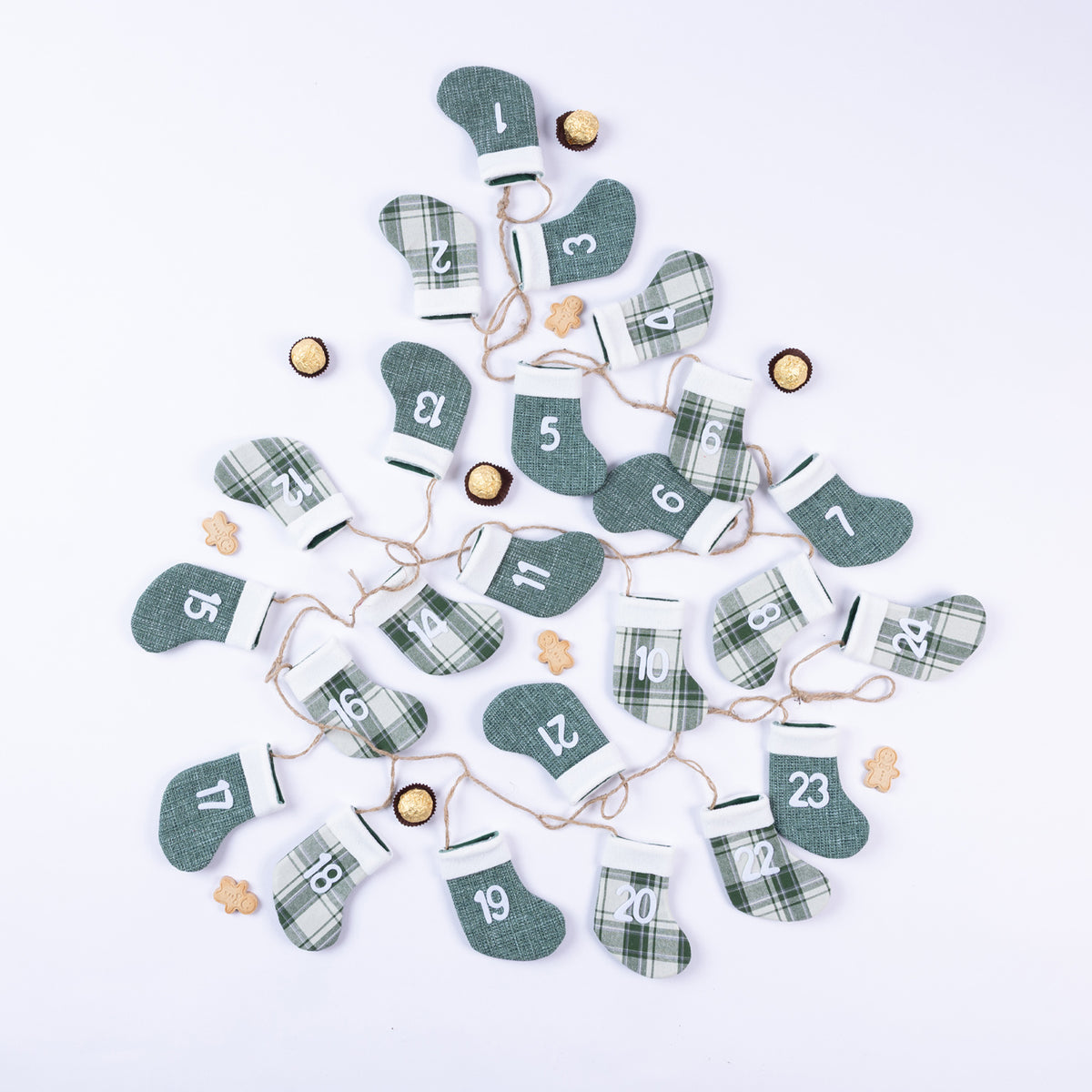 Christmas Wishes String of Boots Advent Calendar Green – Green and plaid stocking-shaped advent calendar featuring 24 numbered pockets connected along a natural twine string.