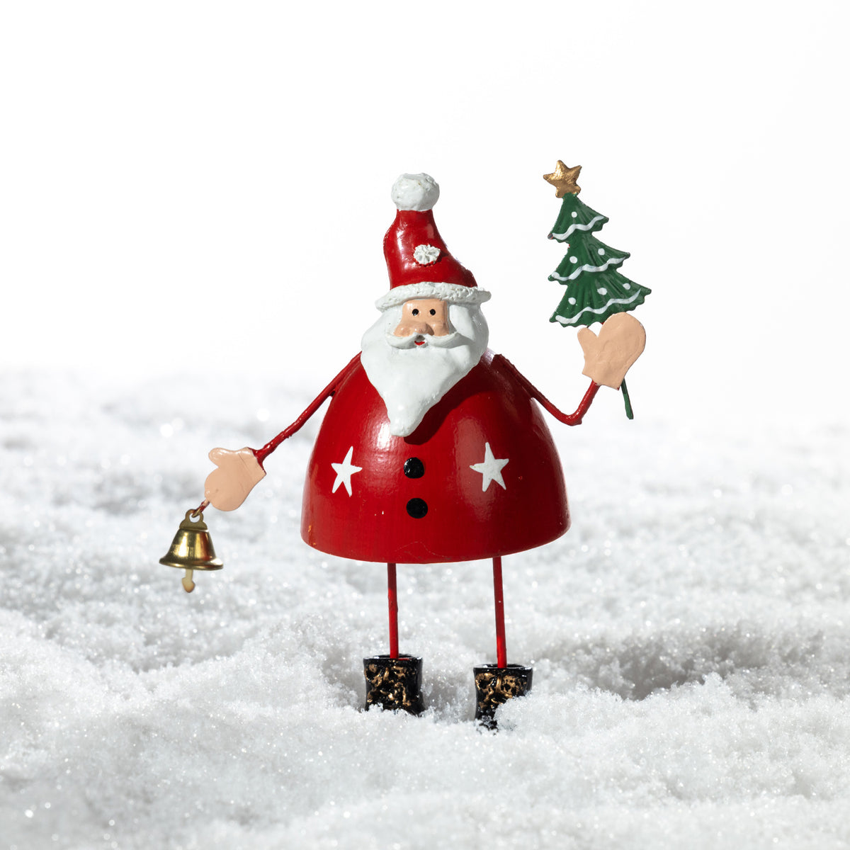 Christmas Wishes Metal Standing Santa Décor Red – Festive metal Santa figure in red holding a miniature Christmas tree and gold bell, displayed in a snowy setting.