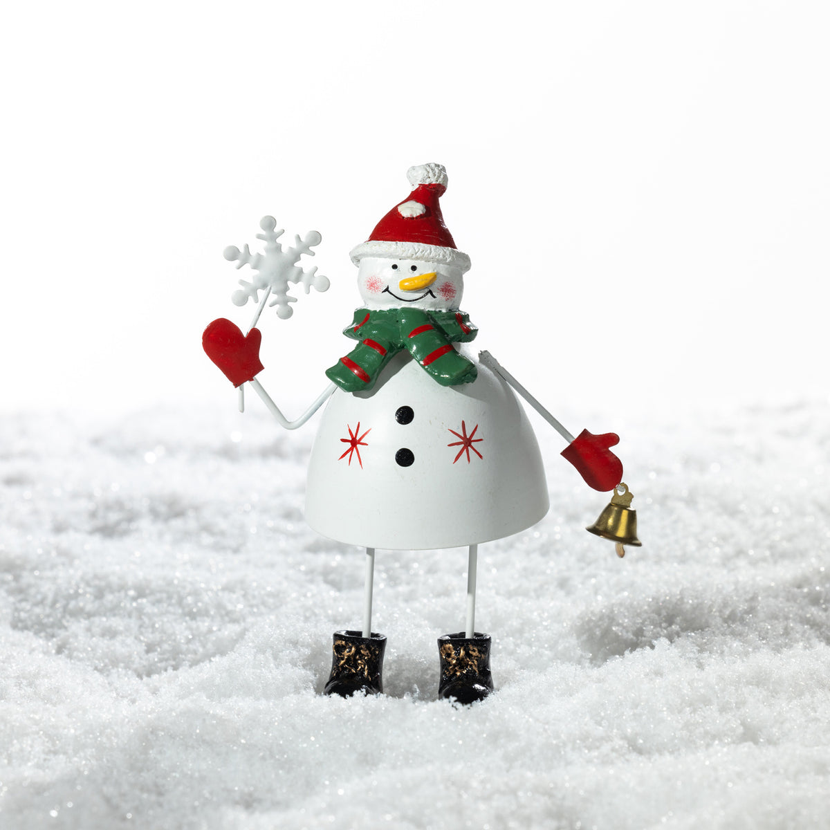 Christmas Wishes Metal Standing Snowman Décor White – Cheerful white metal snowman figure wearing a red Santa hat and green scarf, holding a snowflake and gold bell.