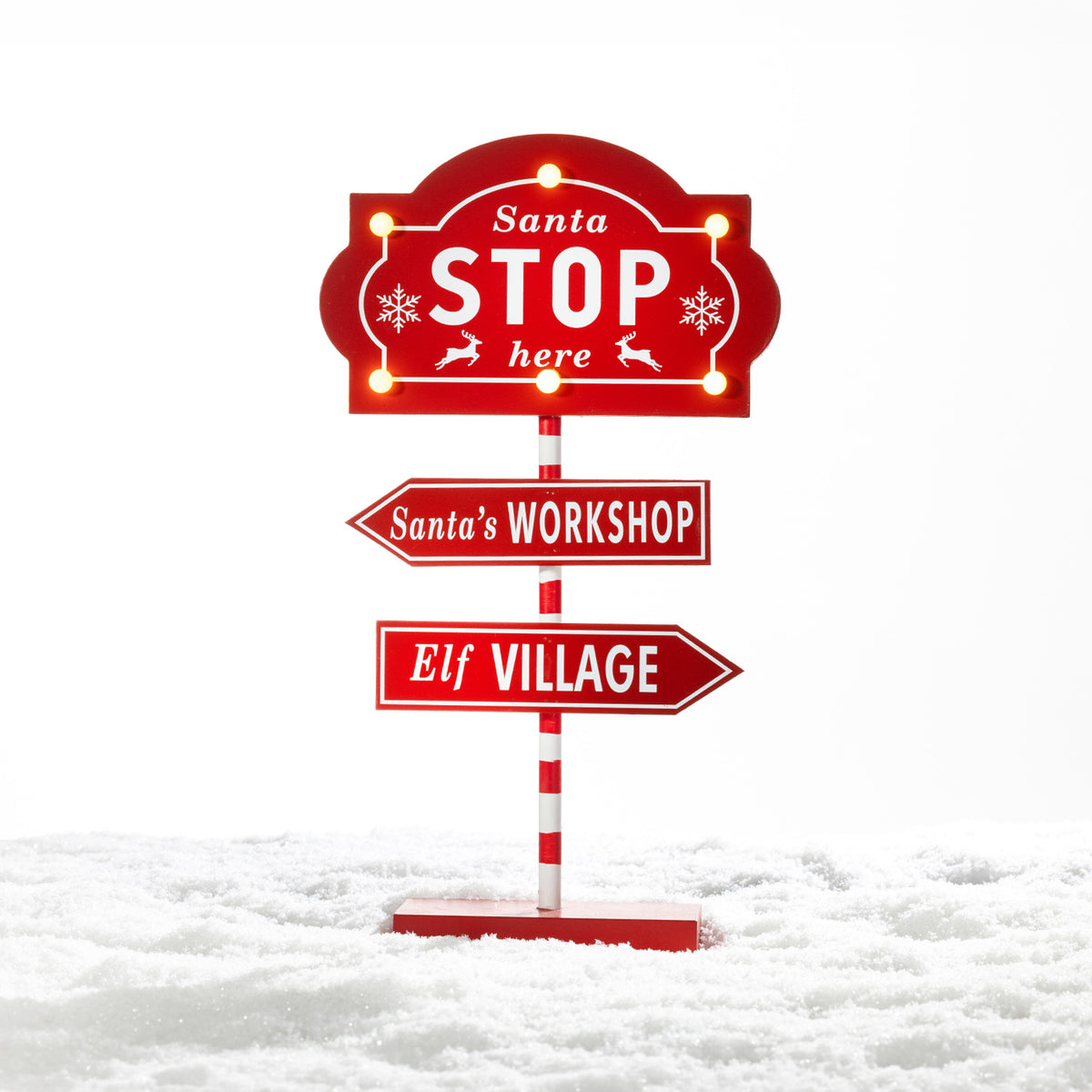 Christmas Wishes Santa Stop Here LED Sign – Freestanding red and white Christmas sign featuring glowing LED lights, “Santa Stop Here”, Santa’s Workshop and Elf Village directional signs.