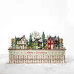 Christmas Wishes Wooden LED Village Advent Calendar – Wooden Christmas village advent calendar with illuminated houses, snowy trees, lamp posts and 24 numbered drawers.