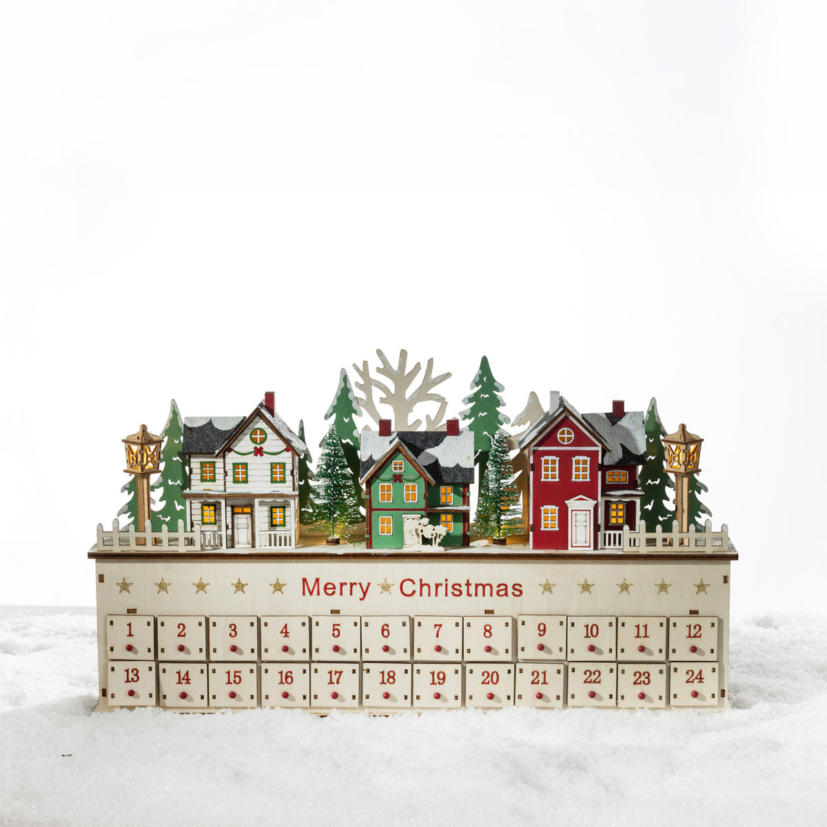 Christmas Wishes Wooden LED Village Advent Calendar – Wooden Christmas village advent calendar with illuminated houses, snowy trees, lamp posts and 24 numbered drawers.