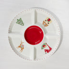 A festive divided serving platter featuring a bold red centre and playful Christmas illustrations of Santa, a reindeer, Christmas tree and house.