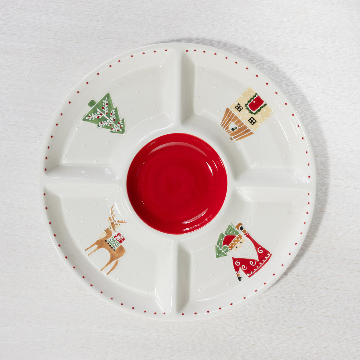 A festive divided serving platter featuring a bold red centre and playful Christmas illustrations of Santa, a reindeer, Christmas tree and house.