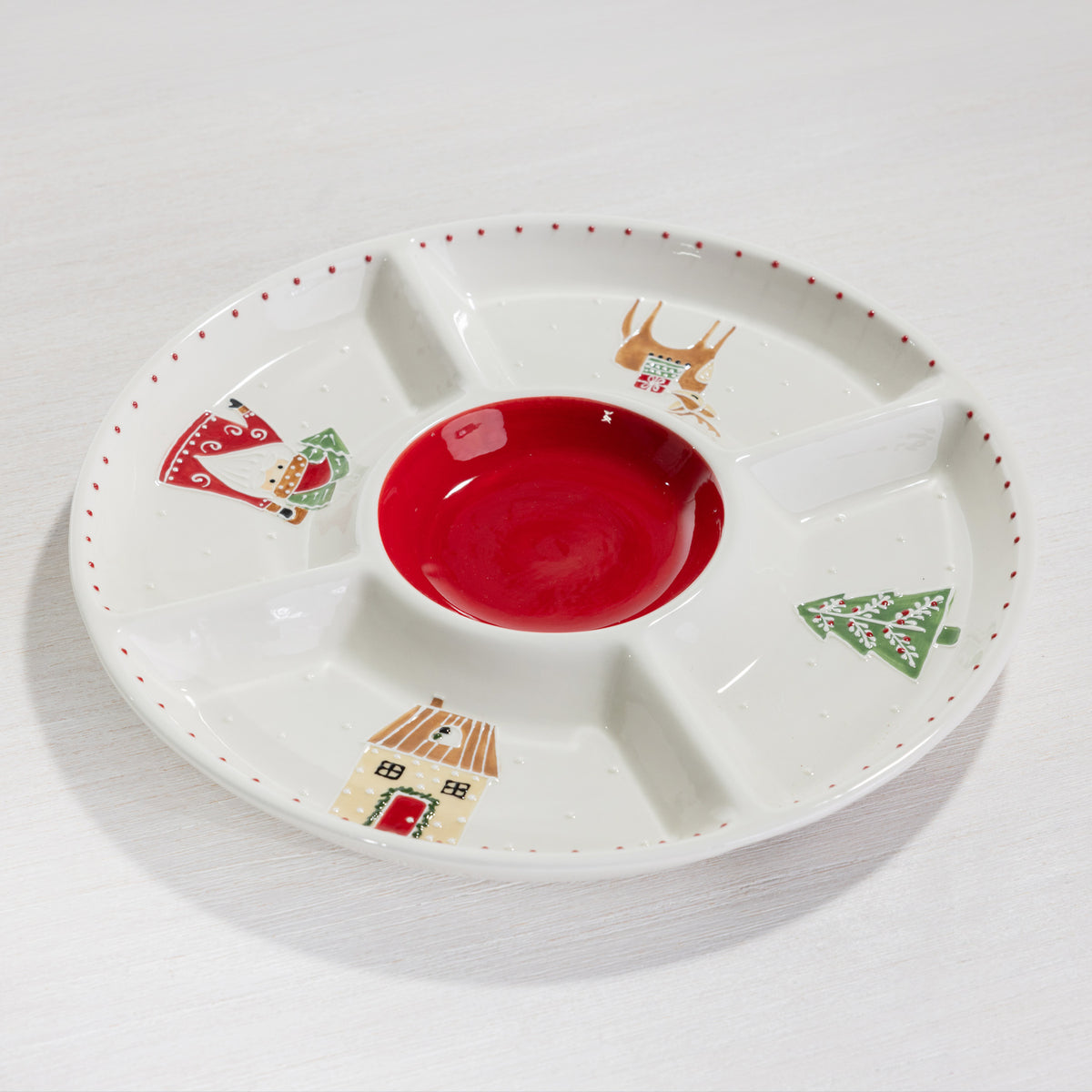 A festive divided serving platter featuring a bold red centre and playful Christmas illustrations of Santa, a reindeer, Christmas tree and house.