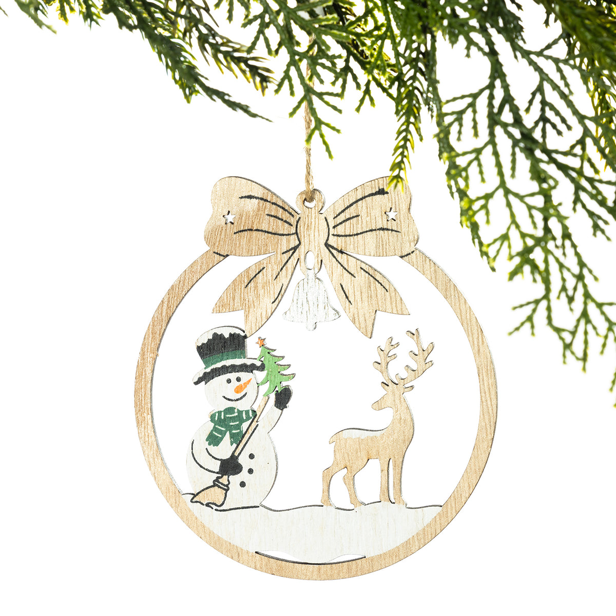 A round wooden Christmas ornament hanging from a pine branch, featuring a cutout snowman and deer design with a large bow at the top.