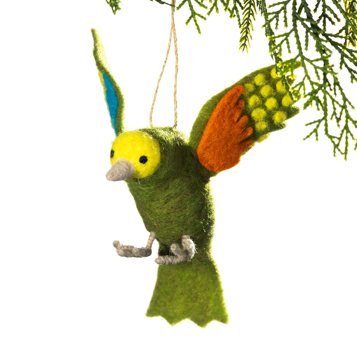 A felted wool bird ornament hanging from a tree branch against a white background. The bird is primarily green with a yellow head, orange wing, and blue-tipped ear.