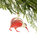 A wooden kiwi Christmas decoration featuring a red and natural wood design, layered feather detailing, a long red beak and a natural hanging cord with a wooden bead, displayed on a Christmas tree branch against a white background.