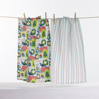 Christmas Wishes Kiwi Christmas tea towel 2 pack with colourful festive New Zealand-inspired print and pale blue striped tea towel hanging on a line.