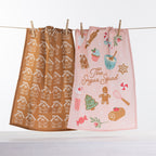 Christmas Wishes Sugar Squad tea towel 2 pack with gingerbread house print and pink festive baking design hanging on a line.