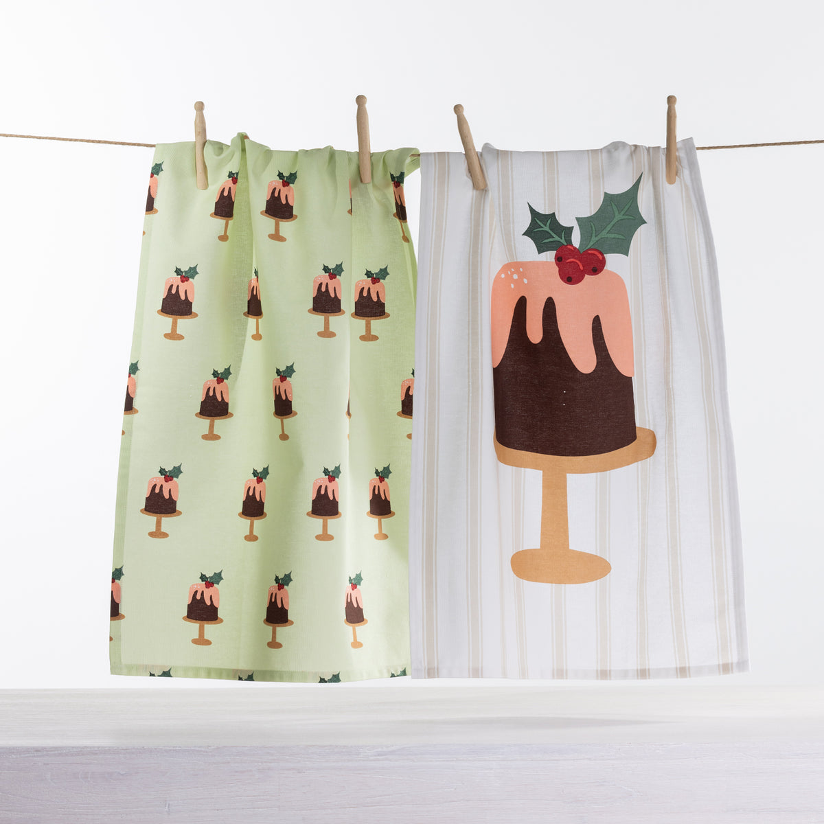 Christmas Wishes Figgy Pudding tea towel 2 pack with green Christmas pudding print and cream striped towel featuring a large festive pudding design.