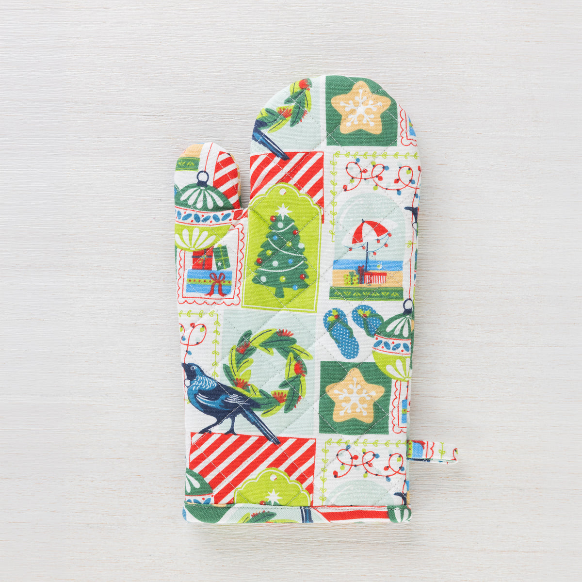 Christmas Wishes Kiwi Christmas oven glove shown individually with the colourful New Zealand-inspired festive print.