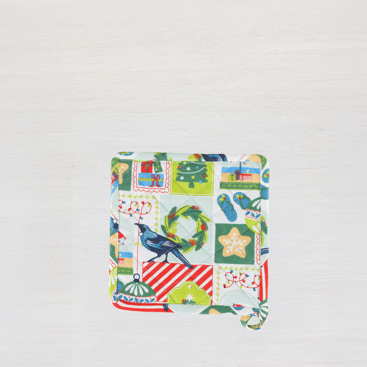 Christmas Wishes Kiwi Christmas pot holder shown individually with the colourful festive patchwork-style print.