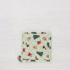 Christmas Wishes Classic Christmas pot holder shown individually, featuring quilted green striped fabric with Christmas trees, gingerbread people, red bows and puddings.