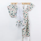 Christmas Wishes Classic Christmas kitchen range hanging from wooden hooks, including coordinating oven gloves, food cover and apron in the green festive print.