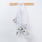 Christmas Wishes Classic Christmas Food Cover hanging from a wooden hook, featuring white mesh with green striped trim and festive Christmas motifs.