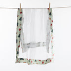 Christmas Wishes Classic Christmas Food Cover hanging against a white background, showing the white mesh body with patterned green striped edging.
