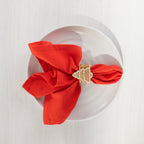 Christmas Wishes red napkin styled on a white plate with a Christmas tree-shaped napkin ring.