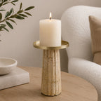 Cove Cement Candle Holder Large Natural styled on a wooden table with a lit pillar candle.