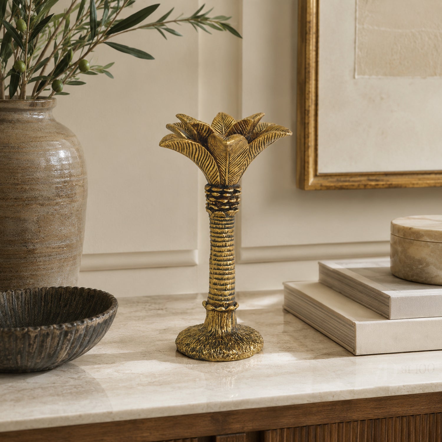 Design Republique Coconut Palm Taper Holder Gold styled on a marble tabletop with neutral décor.